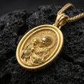 Load image into Gallery viewer, Gold plated rotating Saint Joseph pendant displayed on porous volcanic rock surface, close-up studio composition, detailed oval frame and bail