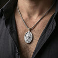 Load image into Gallery viewer, Polished silver Saint Joseph pendant on chain worn on neck, natural lifestyle framing, religious relief clearly visible
