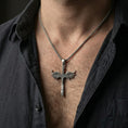 Load image into Gallery viewer, Oxidized Archangel Michael sword pendant necklace worn on neck, lifestyle close-up on dark outfit, winged sword centered