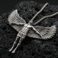 Load image into Gallery viewer, Oxidized Archangel Michael pendant on textured volcanic rock, macro close-up, full-body angel figure with spread wings, premium studio lighting