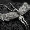 Load image into Gallery viewer, Oxidized Archangel Michael pendant on textured volcanic rock, macro close-up, full-body angel figure with spread wings, premium studio lighting