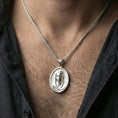 Load image into Gallery viewer, Polished silver Veiled Madonna pendant on chain worn on neck, natural lifestyle framing, Virgin Mary relief clearly visible
