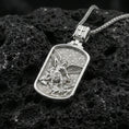 Load image into Gallery viewer, Polished silver Archangel Michael dogtag necklace pendant on black volcanic stone background, crisp rectangular frame and patterned backdrop, high-end product shot
