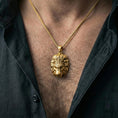 Load image into Gallery viewer, Gold plated lion head pendant necklace worn on neck, warm highlights, statement men’s jewelry look, premium lifestyle photo
