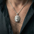 Load image into Gallery viewer, Polished silver lion head pendant necklace on chain, lifestyle framing, ornate lion face and crown detailing clearly visible