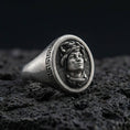 Load image into Gallery viewer, Oxidized sterling silver Medusa signet ring with Greek key border on volcanic rock background