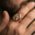 Load image into Gallery viewer, Rose gold plated signet ring on finger, ornate dragon/yokai relief detail, lifestyle wear shot