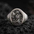 Load image into Gallery viewer, Oxidized: Oxidized sterling silver signet ring with detailed oni/dragon relief on volcanic rock, macro studio shot