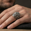 Load image into Gallery viewer, Balinese Barong god sterling silver ring in an oxidized finish worn on finger, detailed guardian mask relief, lifestyle hand close-up
