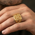 Load image into Gallery viewer, Jerusalem Cross signet ring in a gold plated finish worn on finger, bold crusader cross statement design, masculine lifestyle close-up
