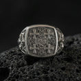 Load image into Gallery viewer, Jerusalem Cross sterling silver signet ring in an oxidized finish on volcanic rock, medieval crusader cross engraving, macro studio product shot
