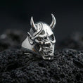 Load image into Gallery viewer, Undead oni mask ring in a gold plated finish on volcanic rock, Japanese demon skull design with sharp horn details, premium macro product image