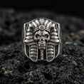Load image into Gallery viewer, Sterling silver pharaoh skull ring in an oxidized finish on volcanic rock, ancient Egypt mummy mask design, macro studio product shot