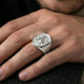 Load image into Gallery viewer, Griffin ring in polished silver finish on finger, winged gryphon emblem detail, natural lifestyle wear shot