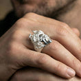Load image into Gallery viewer, Medusa signet ring in polished silver finish on finger, snake goddess head sculpture, natural lifestyle wear shot