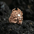 Load image into Gallery viewer, Medusa signet ring in a rose gold plated finish on volcanic rock, ornate gorgon snake hair sculpture, luxury studio close-up