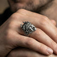 Load image into Gallery viewer, Sterling silver Medusa ring in an oxidized finish worn on finger, gorgon face and snake hair detail visible, lifestyle hand close-up