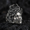 Load image into Gallery viewer, Sterling silver Medusa ring in an oxidized finish on volcanic rock, gorgon goddess portrait with detailed snake hair texture, macro studio product shot