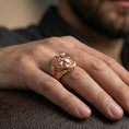 Load image into Gallery viewer, Fenrir wolf ring in a rose gold plated finish on finger, detailed wolf head relief with ornamental border, lifestyle wear photo