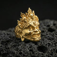 Load image into Gallery viewer, Hindu Yama mask ring in a gold plated finish on volcanic rock, skull-topped crown and bold facial relief, high-end macro jewelry photo