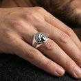 Load image into Gallery viewer, Venus Roman goddess signet ring in polished silver finish on finger, coin-inspired portrait relief and geometric side details, lifestyle wear shot