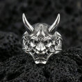 Load image into Gallery viewer, Oni demon mask ring in polished silver finish on volcanic rock, raised samurai-inspired yokai faceplate, premium close-up jewelry photo