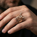 Load image into Gallery viewer, Hannya mask ring in a rose gold plated finish worn on finger, detailed demon facial features and horns, lifestyle macro shot