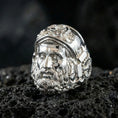 Load image into Gallery viewer, Polished silver Hephaestus ring on volcanic rock, crisp sculpted face design inspired by Greek mythology and craftsmanship