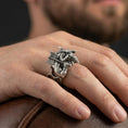 Load image into Gallery viewer, Oxidized sterling silver Minotaur ring worn on finger, bold Greek mythology beast design with horns and axe, masculine lifestyle hand shot