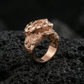 Load image into Gallery viewer, Rose gold plated Foo Dog ring showcasing bold guardian lion design with intricate ornamental engraving, sharp close-up product photography on volcanic rock