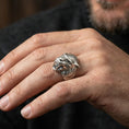 Load image into Gallery viewer, Oxidized sterling silver werewolf head ring worn on finger, bold gothic wolf face with fangs, masculine lifestyle hand shot