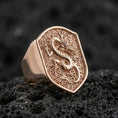 Load image into Gallery viewer, Rose gold plated Chinese dragon ring showcasing coiled dragon on shield signet face with detailed scales, sharp close-up product photography on volcanic rock