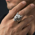 Load image into Gallery viewer, Polished sterling silver Oni mask ring on a human finger, horned demon face signet, crisp sculpted details, heavy statement ring