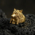Load image into Gallery viewer, Gold plated wolf headdress skull ring on black volcanic stone, tribal wolf warrior design, sculpted fur and skull details