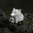 Load image into Gallery viewer, Polished sterling silver wolf headdress skull ring on black volcanic stone, detailed wolf head carving with skull base, bold warrior jewelry