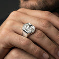 Load image into Gallery viewer, Polished sterling silver dragon ring on a human finger, detailed mythological dragon engraving, strong statement look