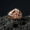 Load image into Gallery viewer, Rose gold plated dragon skull ring on black volcanic stone, sculpted dragon figure with skull pile, fantasy statement ring