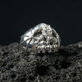 Load image into Gallery viewer, Polished sterling silver dragon skull ring on black volcanic stone, detailed dragon and skull relief, dark fantasy jewelry