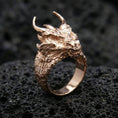 Load image into Gallery viewer, Rose gold plated horned dragon ring on black volcanic stone, dragon head design with textured scales, fantasy accessory