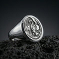 Load image into Gallery viewer, Polished sterling silver dragon signet ring on black volcanic stone, engraved medieval dragon emblem, mythical jewelry