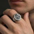 Load image into Gallery viewer, Oxidized sterling silver dragon signet ring worn on a human finger, medieval dragon relief, bold fantasy signet ring