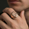 Load image into Gallery viewer, Rose gold plated dragon signet ring on a human finger, ornate winged dragon motif, myth-inspired jewelry