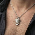 Load image into Gallery viewer, Polished sterling silver Statue of Liberty pendant on a human neck, New York City charm, braided chain necklace