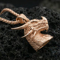 Load image into Gallery viewer, Rose gold plated dragon head pendant on matte volcanic stone, intricate reptile scales and curved horns, crisp macro focus