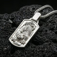 Load image into Gallery viewer, Polished silver zodiac tiger necklace pendant on dark volcanic stone, crisp engraved stripes and claw details, premium close-up composition