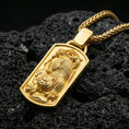 Load image into Gallery viewer, Gold plated Chinese tiger tag pendant on porous volcanic rock backdrop, bold roaring tiger design with detailed linework, high-contrast lighting