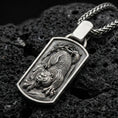 Load image into Gallery viewer, Oxidized sterling silver Chinese tiger pendant on textured volcanic rock, roaring tiger relief in rectangular tag frame, macro studio shot