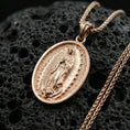 Load image into Gallery viewer, Rose gold plated Guadalupe oval pendant on matte volcanic stone, intricate Virgin Mary engraving and halo-style border, sharp macro focus