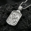 Load image into Gallery viewer, Polished silver St Christopher necklace pendant on dark volcanic stone, crisp “St Christopher” text and detailed figure engraving, premium close-up