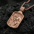 Load image into Gallery viewer, Rose gold plated St Christopher medal pendant on matte volcanic stone, intricate religious relief and patterned background, sharp macro focus
